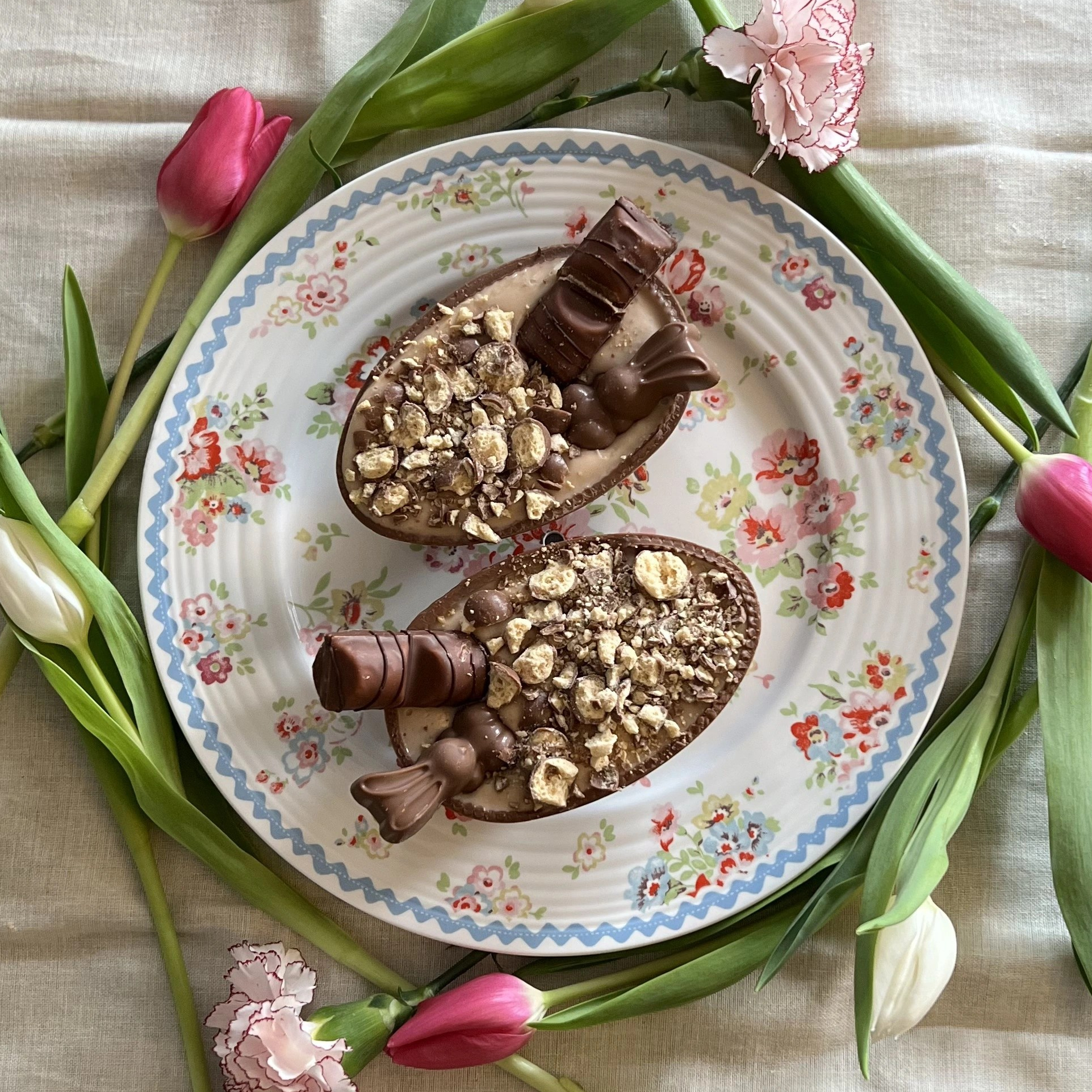 Easter Egg Cheesecakes surrounded by flowers